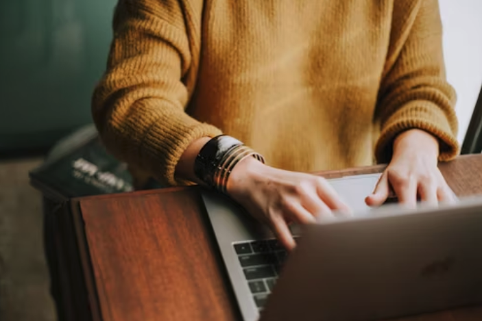Woman typing on computer